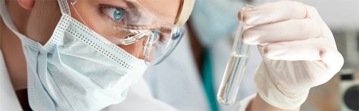 Asistent laboratória skúma test na prítomnosť hormónu prolaktínu