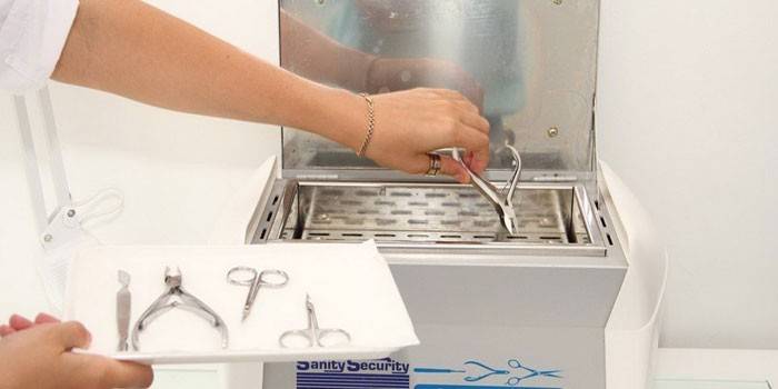 Niña pone herramientas de manicura en el esterilizador