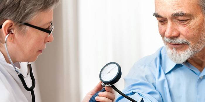 Medic mede a pressão de um homem