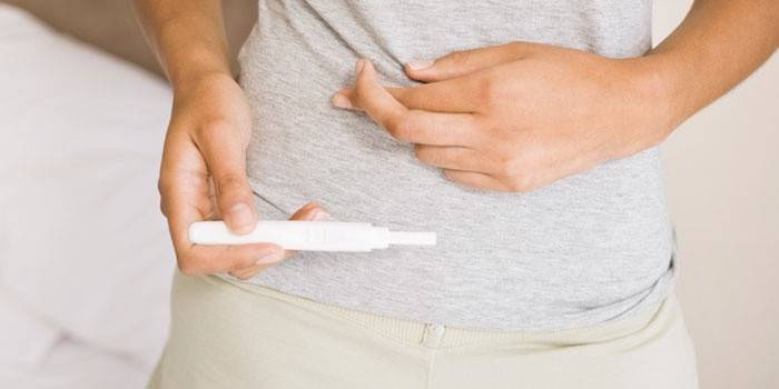 Teste de gravidez nas mãos de uma mulher