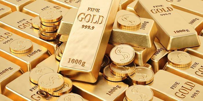 Barras de ouro e moedas