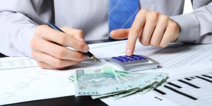 Mężczyzna z kalkulatorem i pieniądze