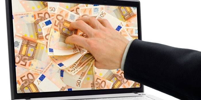 Billetes de un dólar en la pantalla del portátil