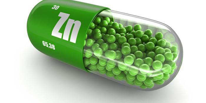 Cápsula con bolas verdes y el icono de zinc