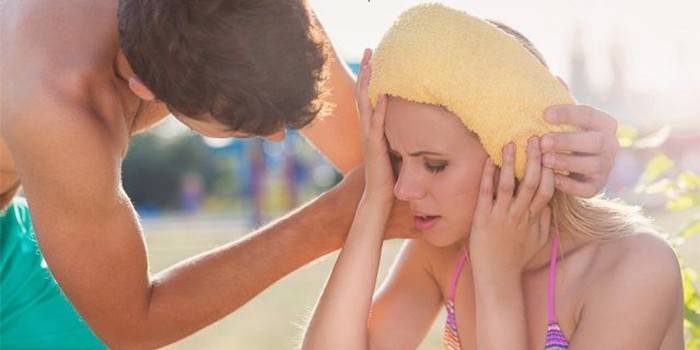El chico brinda primeros auxilios a una niña con un golpe de calor.