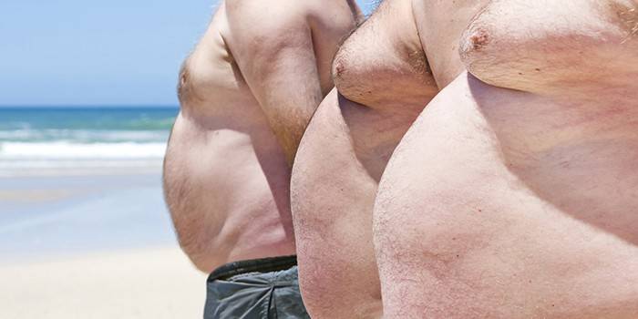 Nadwagą mężczyźni na plaży