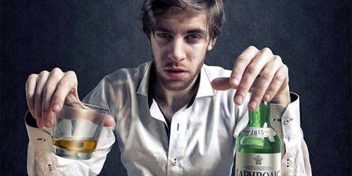 Opitý muž s alkoholom v rukách.