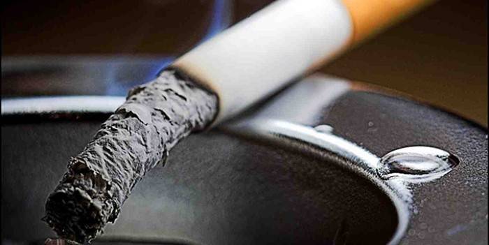 Cigarro fumegante em um cinzeiro
