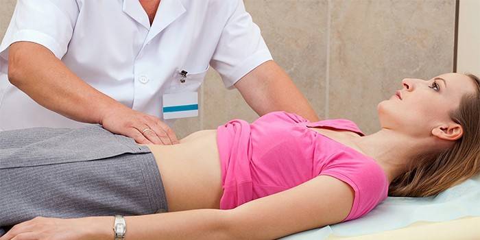 Médico realiza palpação do abdômen de uma menina